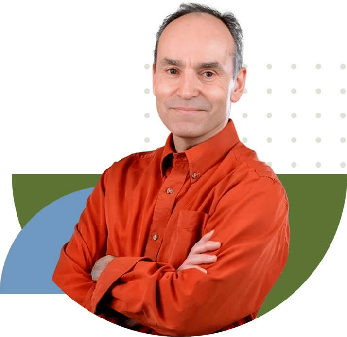 A man in an orange shirt with his arms crossed.